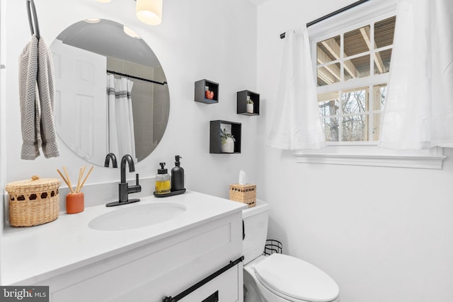 bathroom featuring toilet and vanity