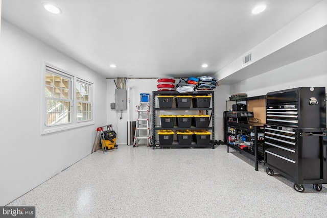 garage featuring electric panel, visible vents, and recessed lighting