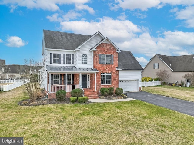 traditional-style home featuring driveway, fence, covered porch, an attached garage, and brick siding