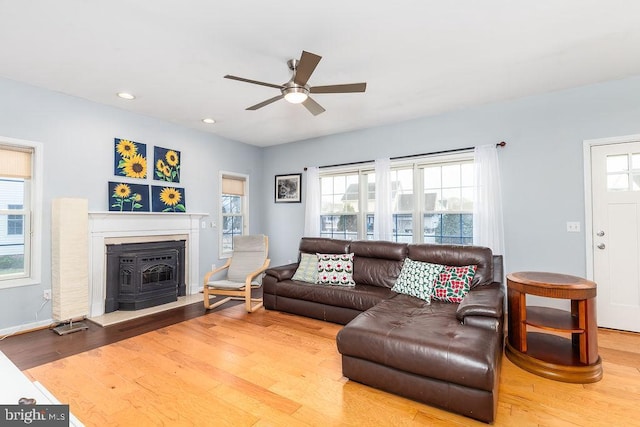 living room featuring recessed lighting, baseboards, a ceiling fan, and wood finished floors