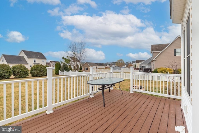 wooden terrace featuring a yard, fence, and a residential view