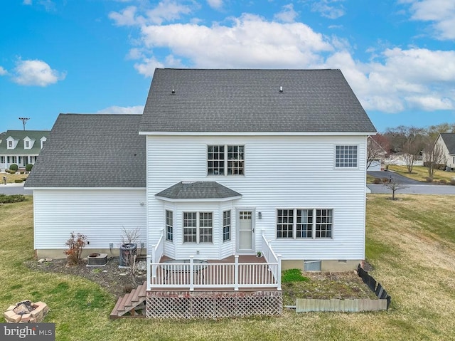 back of house featuring a lawn, central AC, a deck, and roof with shingles