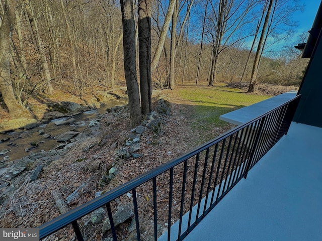 balcony featuring a view of trees