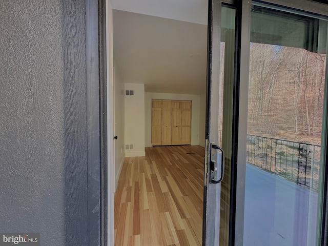 entrance to property with visible vents and a balcony