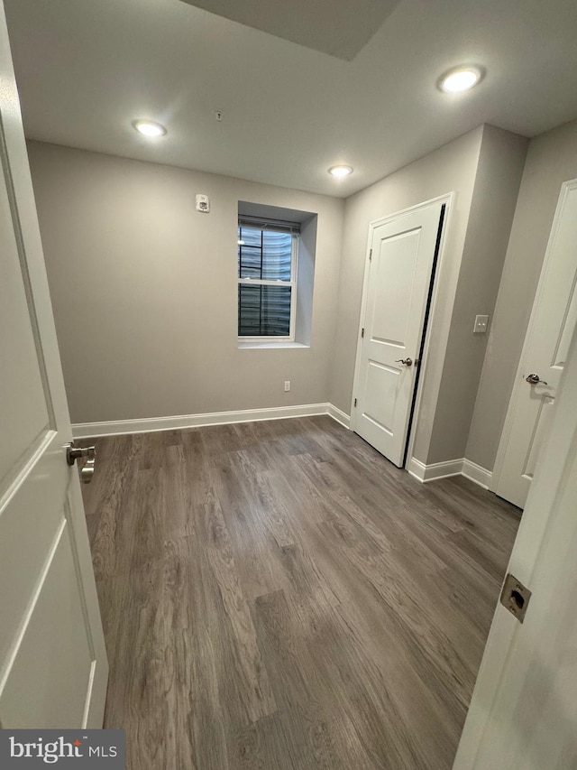 interior space with recessed lighting, dark wood-style floors, and baseboards