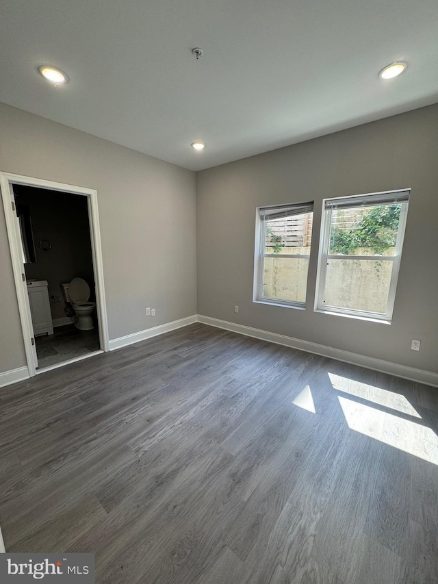 unfurnished bedroom featuring recessed lighting, baseboards, and dark wood-style flooring