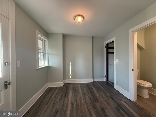 unfurnished bedroom with dark wood-style floors and baseboards