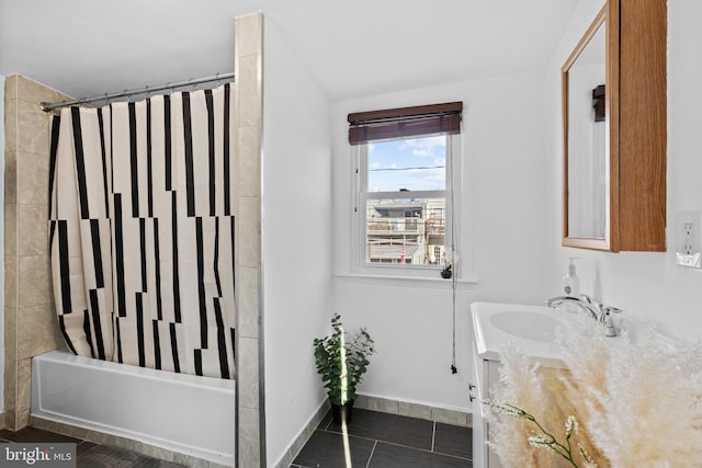 bathroom featuring tile patterned floors, vanity, baseboards, and shower / bathtub combination with curtain