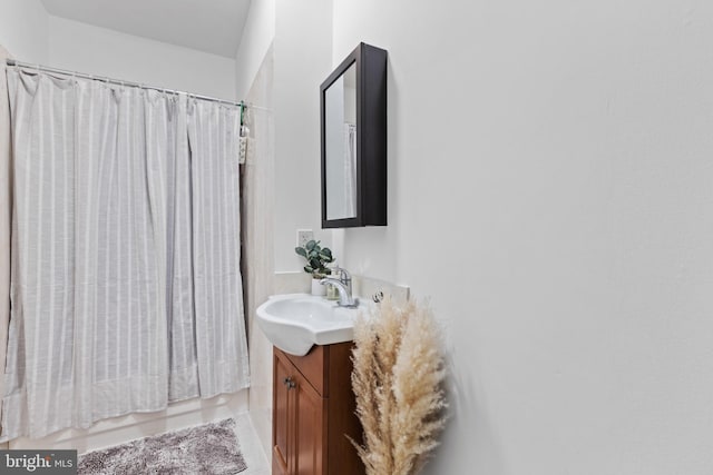 bathroom featuring tile patterned floors, shower / bath combination with curtain, and vanity