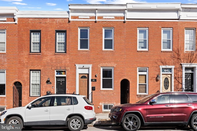 view of property featuring brick siding