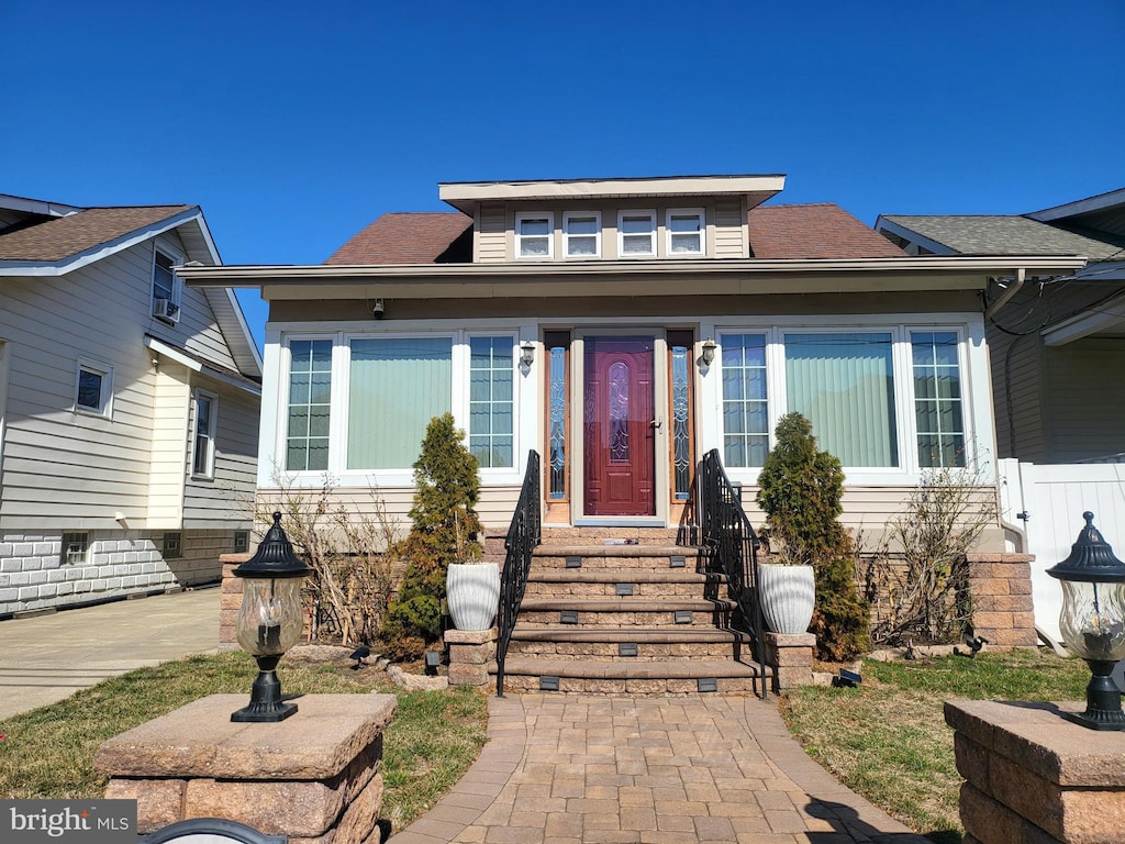 bungalow-style house with a shingled roof