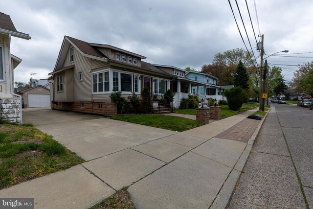 1858 47th St, Pennsauken, NJ 08110 - view of front of property featuring concrete driveway, a shingled roof, and an outdoor structure