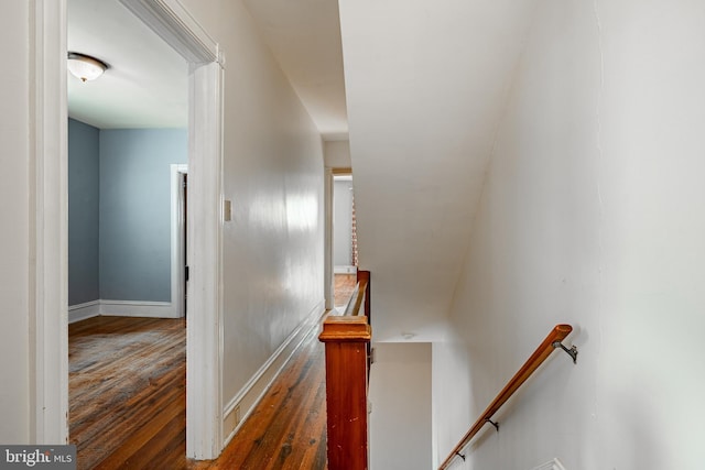 stairway with baseboards and hardwood / wood-style flooring