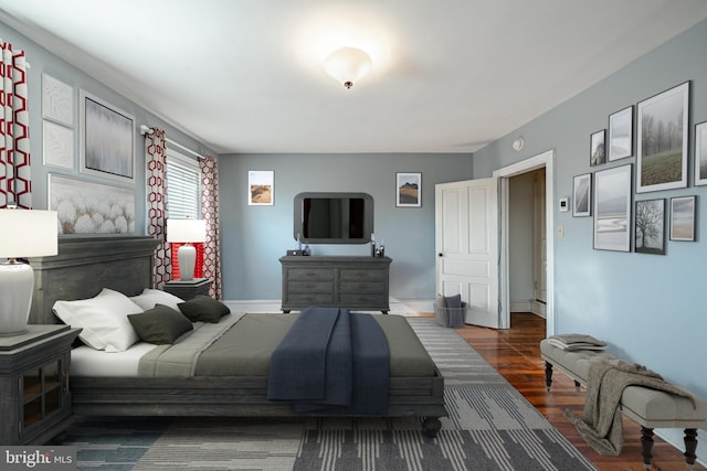 bedroom featuring wood finished floors and baseboards