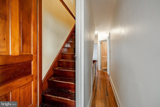 stairs featuring baseboards and hardwood / wood-style floors