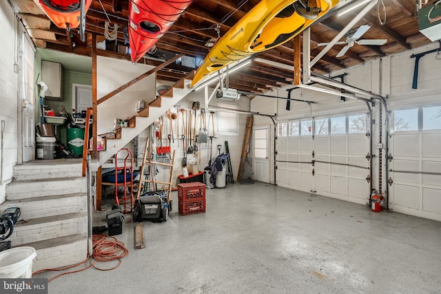 garage with a garage door opener and a ceiling fan