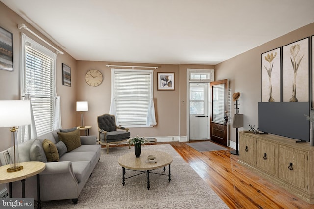 living room featuring baseboards and wood finished floors