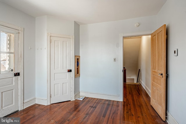 unfurnished bedroom featuring baseboards and hardwood / wood-style floors