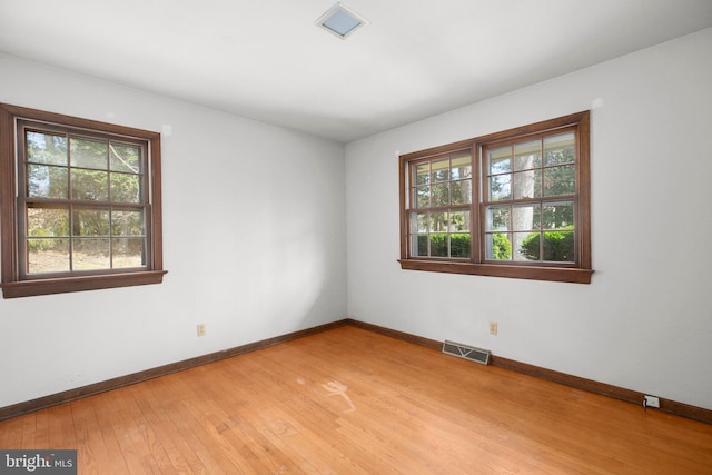 13360 Fredericksburg Tpke, Woodford, VA 22580 - unfurnished room featuring light wood-style flooring, a wealth of natural light, baseboards, and visible vents
