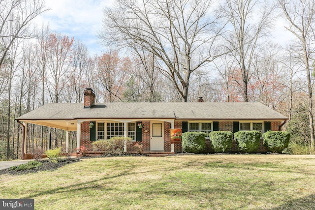 13360 Fredericksburg Tpke, Woodford, VA 22580 - view of front of property with a chimney, concrete driveway, brick siding, a front lawn, and a carport