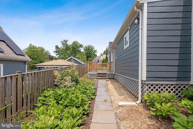 view of yard featuring a deck and fence