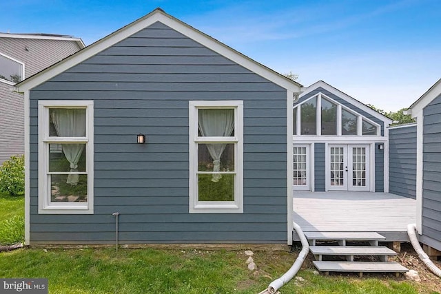 view of side of home featuring french doors and a wooden deck