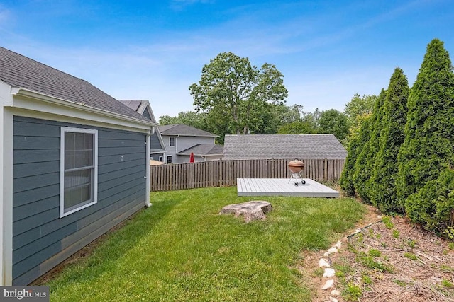 view of yard with a wooden deck and fence