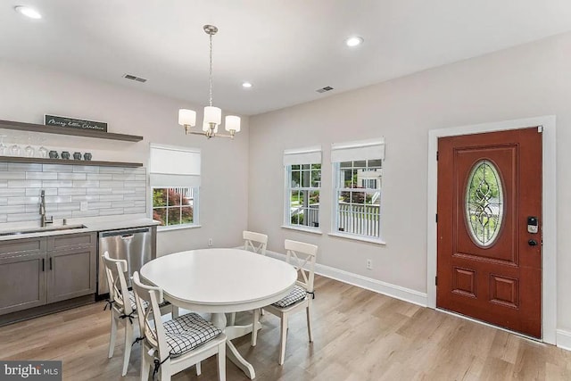 dining room with recessed lighting, visible vents, light wood-type flooring, and a chandelier