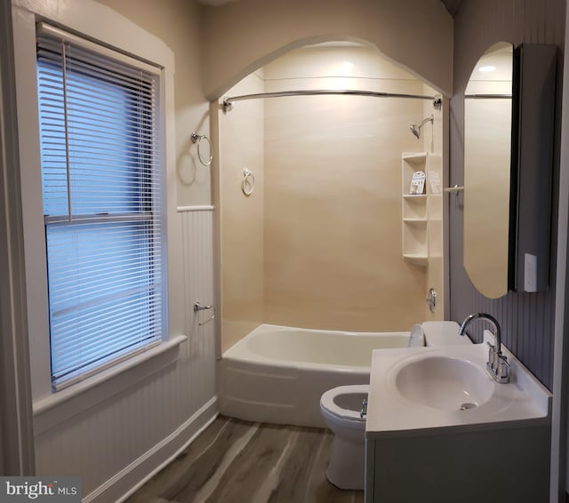 full bath with shower / bathing tub combination, toilet, wood finished floors, and vanity