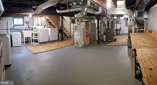 basement featuring stairway, washing machine and dryer, water heater, and a sink