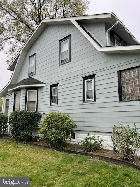 view of home's exterior with a lawn