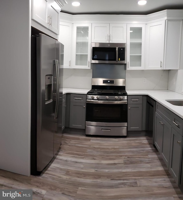 kitchen with light countertops, gray cabinets, and appliances with stainless steel finishes