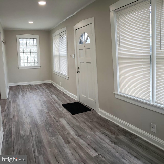 foyer with recessed lighting, ornamental molding, baseboards, and wood finished floors