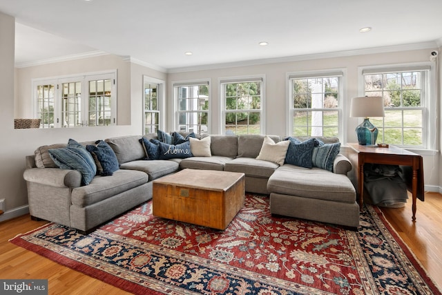 living room featuring recessed lighting, crown molding, baseboards, and wood finished floors