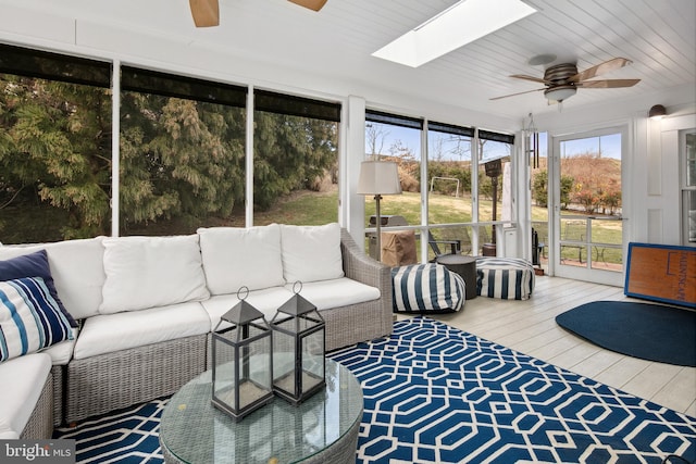 sunroom / solarium with a skylight and ceiling fan