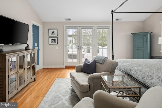 bedroom featuring visible vents, light wood-style floors, french doors, and access to outside