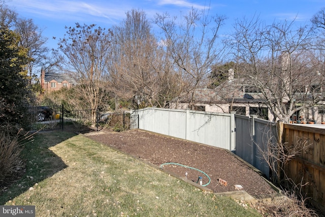 view of yard featuring a fenced backyard and a gate