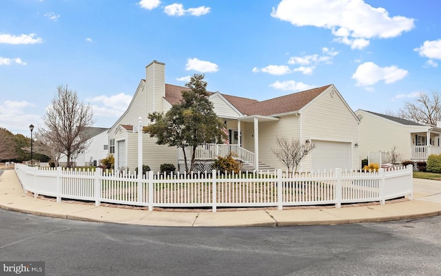 ranch-style house with a garage, a fenced front yard, and a chimney