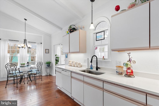 kitchen featuring a sink, lofted ceiling with beams, wood-type flooring, white dishwasher, and light countertops