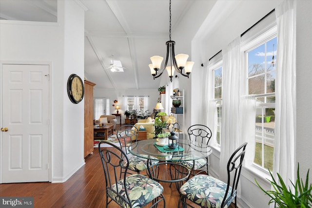 dining room with a chandelier, a healthy amount of sunlight, lofted ceiling with beams, and dark wood-style flooring