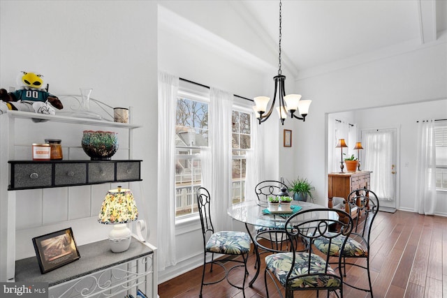 dining space with wood finished floors, baseboards, a chandelier, and a healthy amount of sunlight