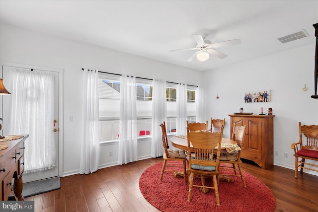 dining area featuring visible vents, baseboards, ceiling fan, and hardwood / wood-style flooring