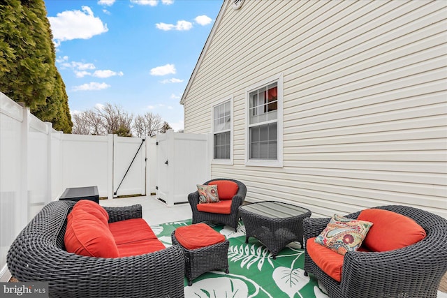 view of patio / terrace featuring an outdoor living space, a gate, and fence