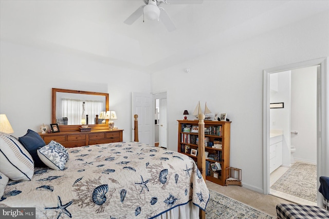 bedroom with carpet flooring, a ceiling fan, baseboards, and ensuite bathroom