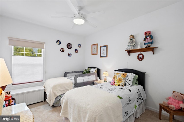 bedroom featuring radiator, baseboards, a ceiling fan, and carpet floors