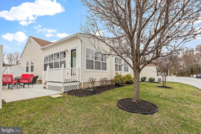 view of home's exterior featuring a patio area, a yard, and fence