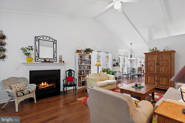 living room with wood finished floors, high vaulted ceiling, beam ceiling, a fireplace with flush hearth, and ceiling fan with notable chandelier