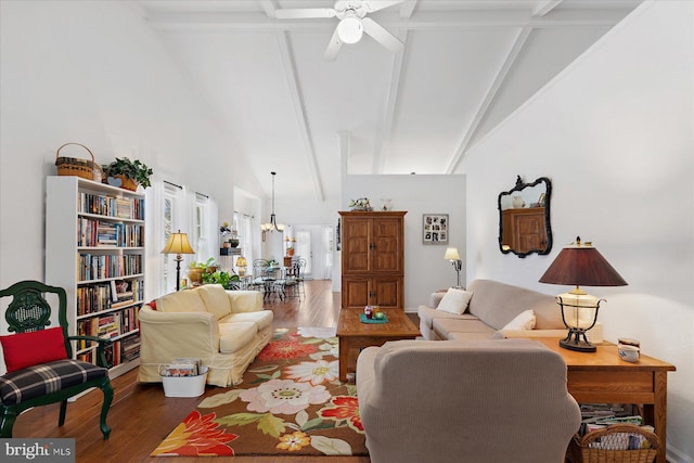 living area with a ceiling fan, beamed ceiling, wood finished floors, and high vaulted ceiling