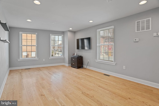 unfurnished living room with recessed lighting, visible vents, and baseboards