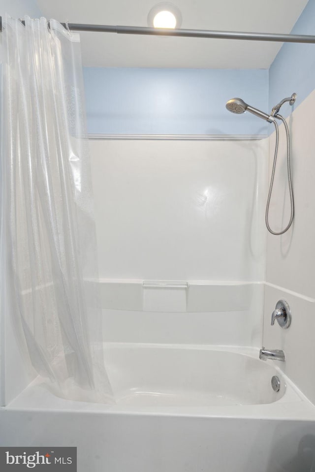 full bath featuring shower / tub combo with curtain